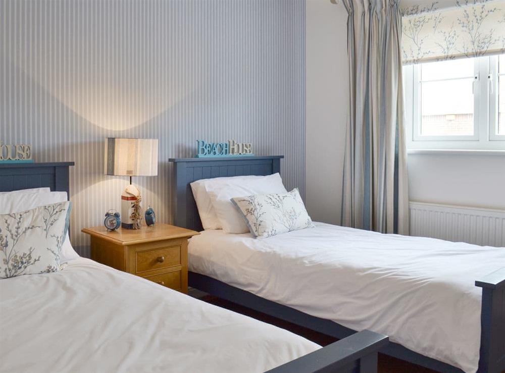Comfortable twin bedroom at The Tides in Bridport, Dorset