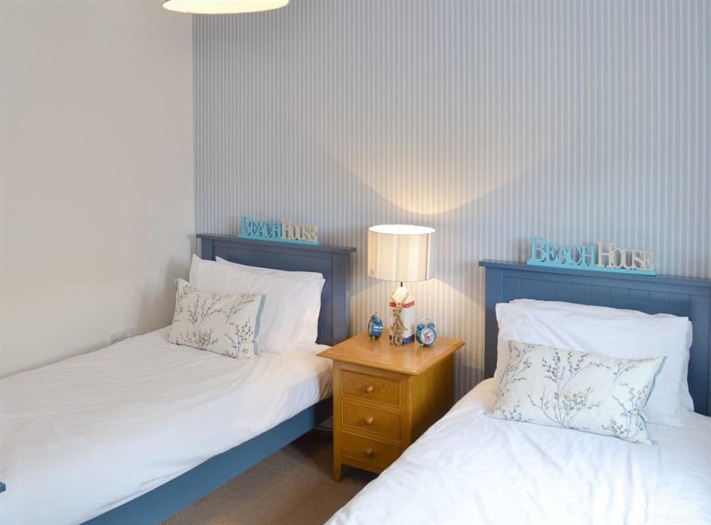 Good-sized twin bedroom at The Tides in Bridport, Dorset