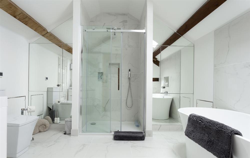 Bathroom with walk in shower and freestanding bath at The Timber Barn, Downton-on-the-Rock