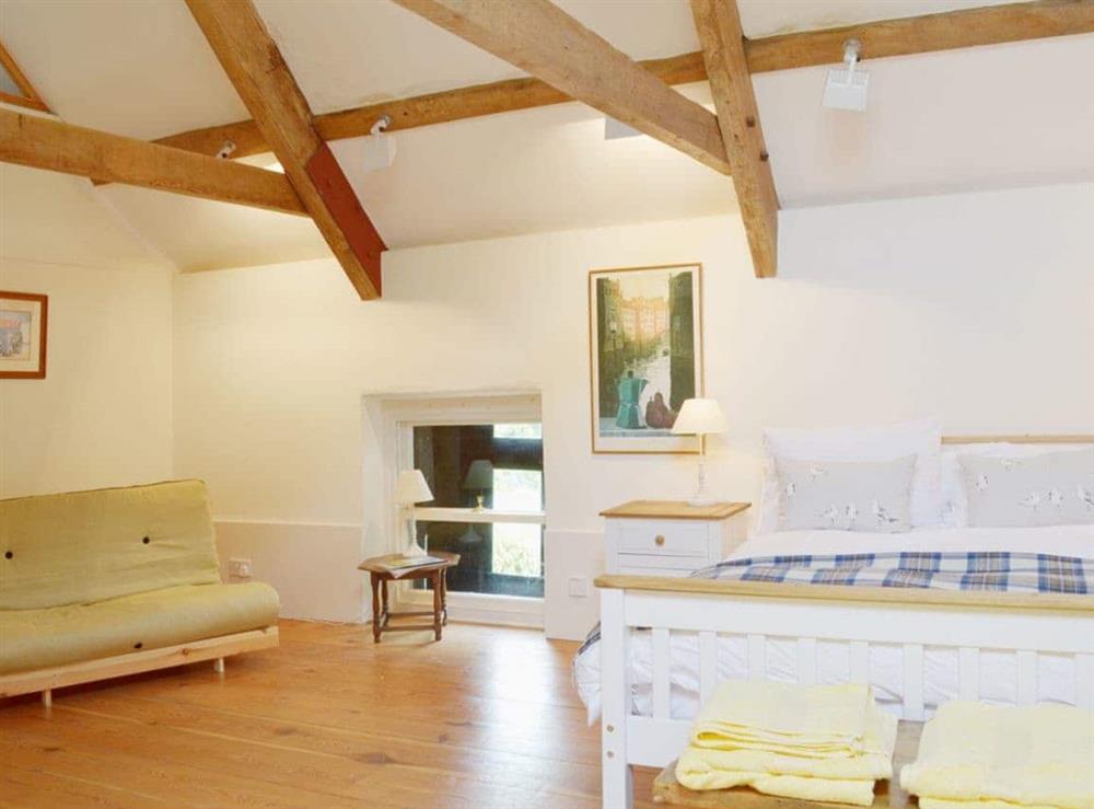 Beautiful wooden floors make the double bedroom sumptuous and luxurious at The Tithe Barn in Huxham, near Exeter, Devon