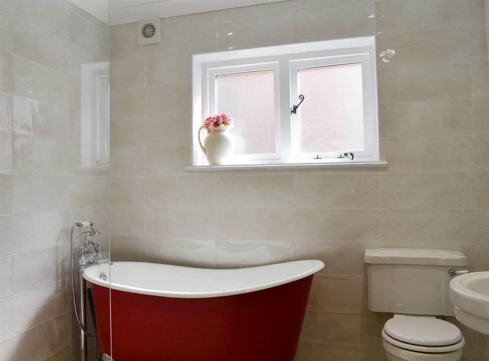 Well presetned bathroom with ¾ roll-top bath and shower cubicle at The Town House in Wimborne, Dorset