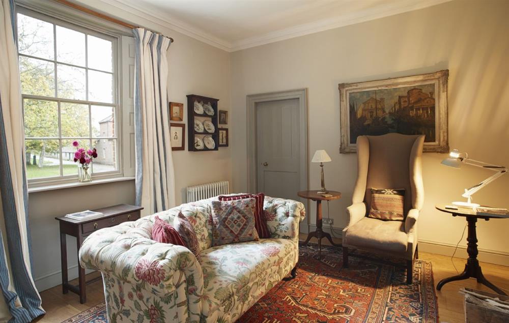 The splendid sitting room with open fireplace at The Treasury, Aylsham near Norwich