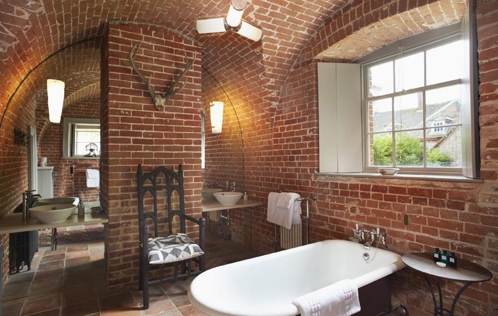 Vaulted brick bathroom with cast iron bath at The Treasury, Aylsham near Norwich