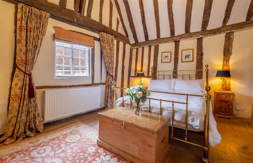 Bedroom one with 5’ king-size bed and vaulted ceiling at The Tryst, Lavenham