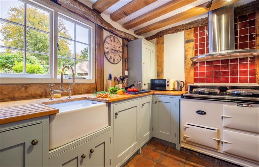 Kitchen with Aga, butler’s sink, wooden cabinets and beams at The Tryst, Lavenham