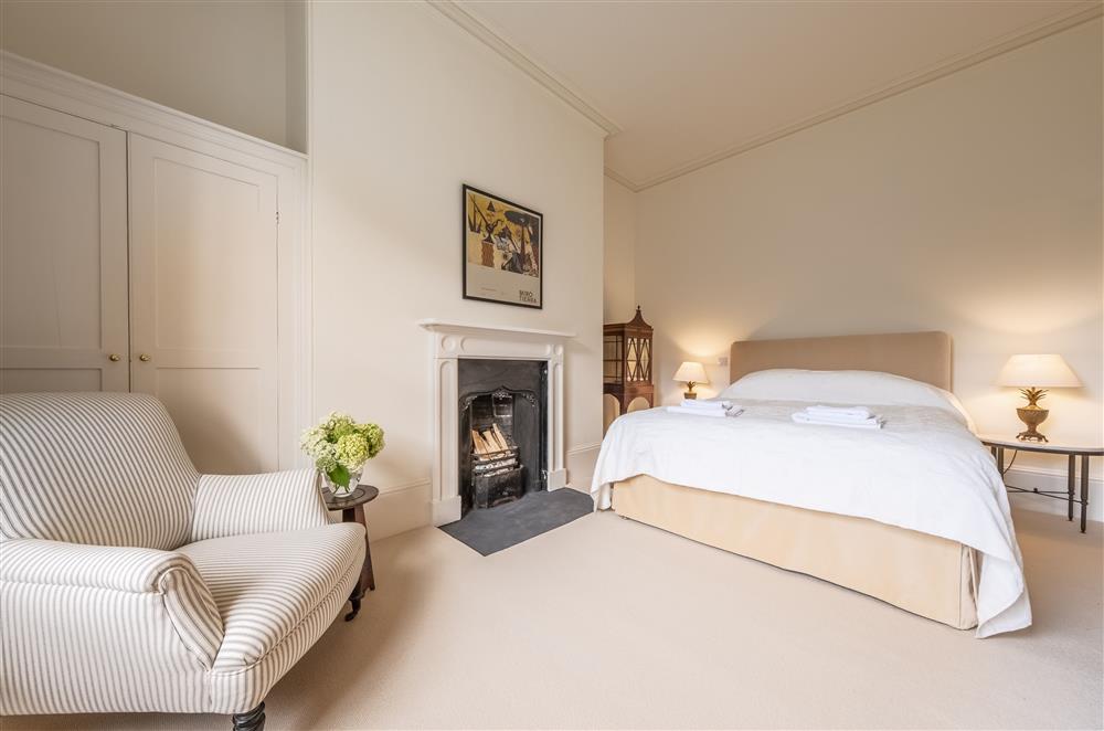 Bedroom one with a 5’ king-size bed at The Vicarage and Cottage, Great Limber