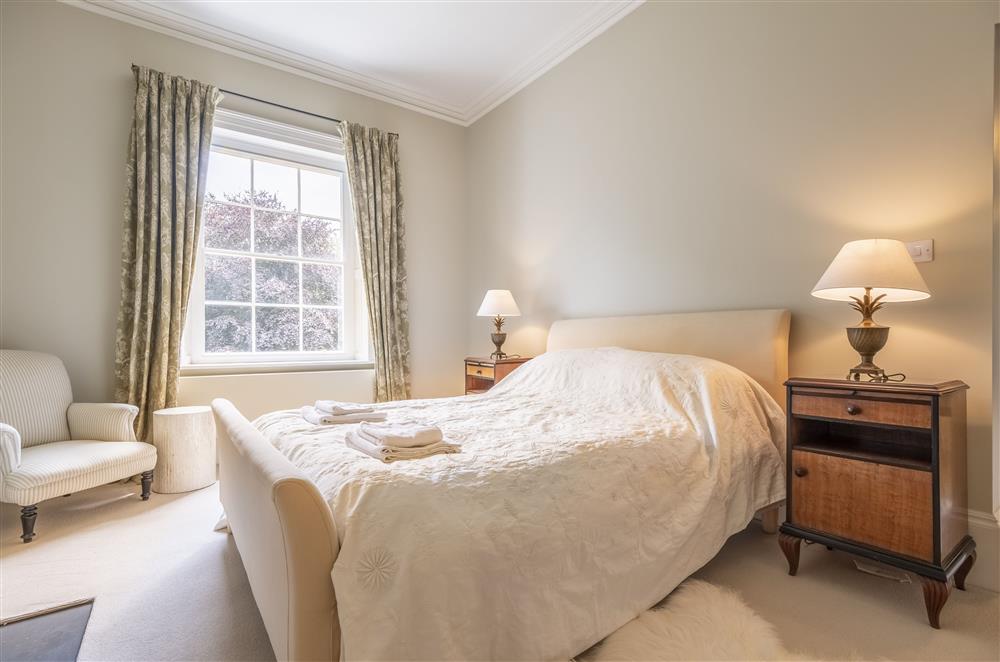 Bedroom two with a 5’ king-size bed at The Vicarage and Cottage, Great Limber
