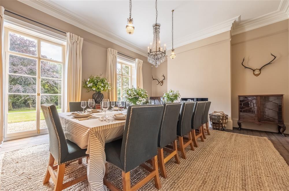 Elegant dining room with wood burning stove at The Vicarage and Cottage, Great Limber