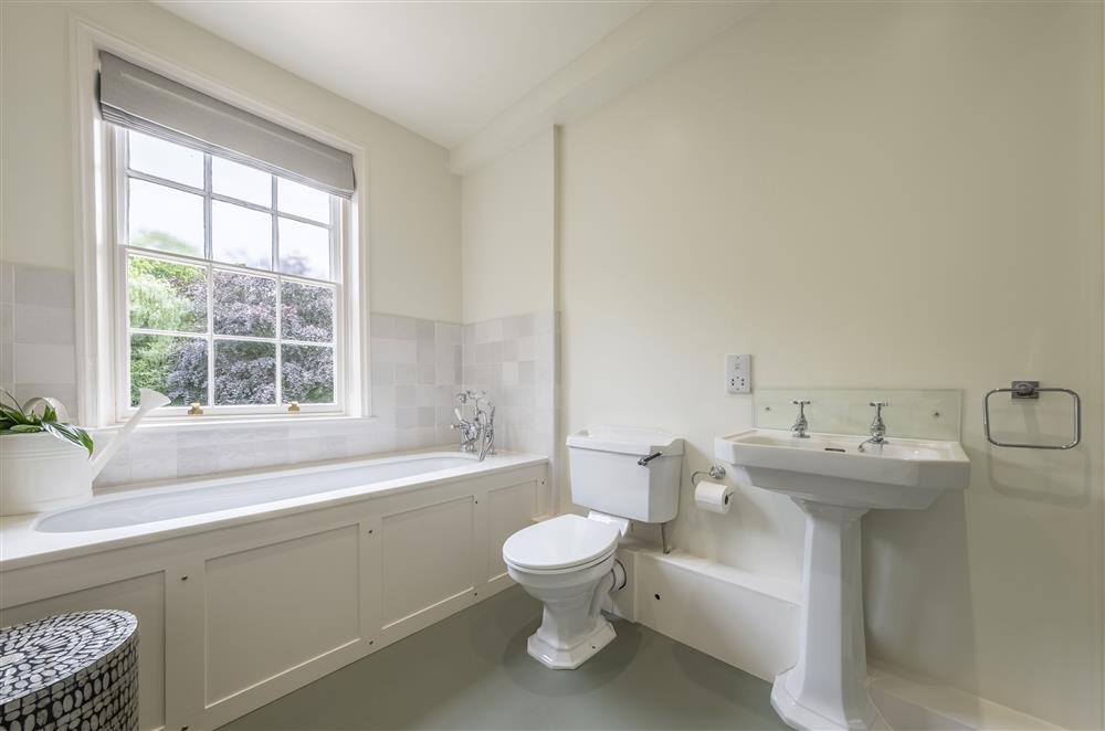 Family bathroom with a bath and hand-held shower at The Vicarage and Cottage, Great Limber