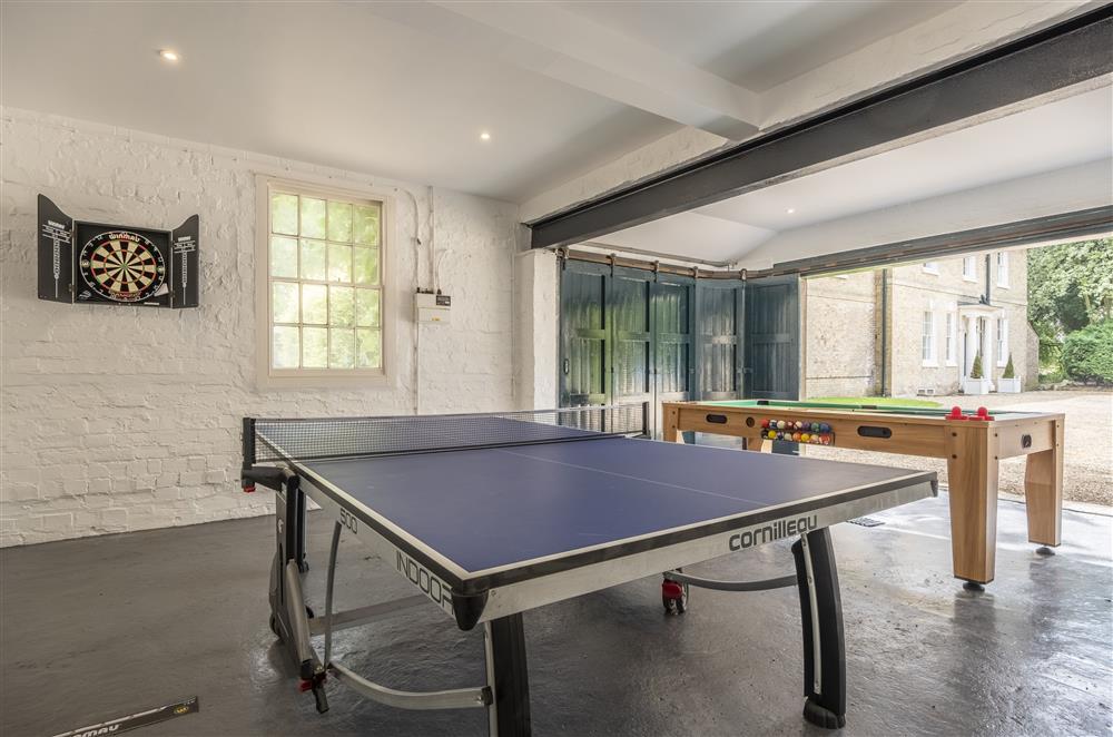 Games room with wood burning stove, table tennis, air hockey and darts board  at The Vicarage and Cottage, Great Limber