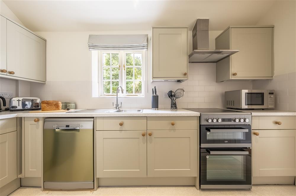 Kitchen with electric oven and hob and dishwasher at The Vicarage and Cottage, Great Limber