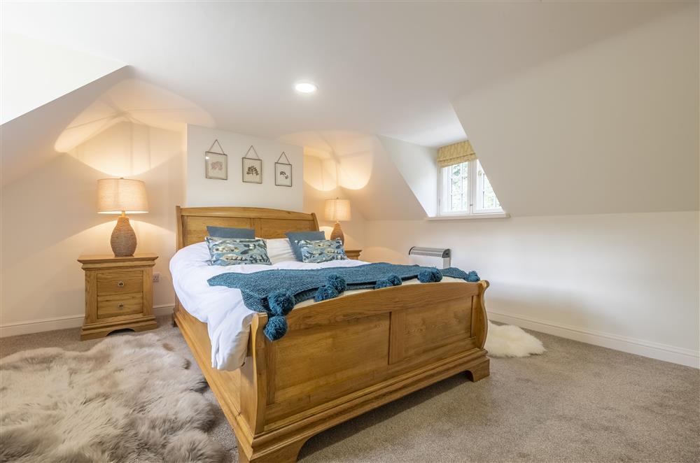 Refined bedroom one with a 4’6 double bed at The Vicarage and Cottage, Great Limber