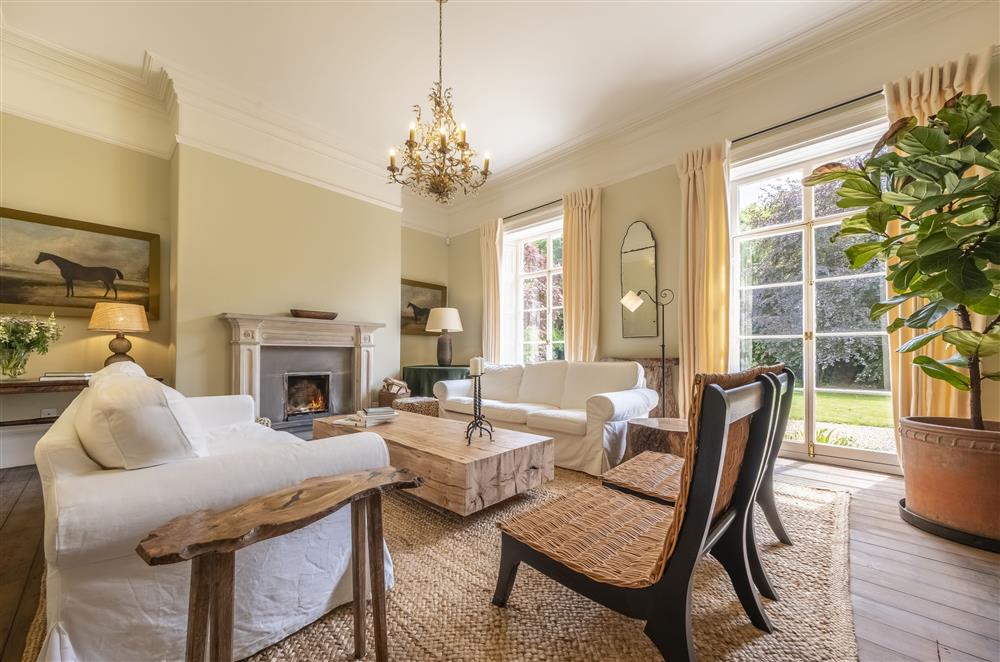 The beauty of the drawing room is enhanced by natural light with french doors leading to the garden at The Vicarage, Great Limber