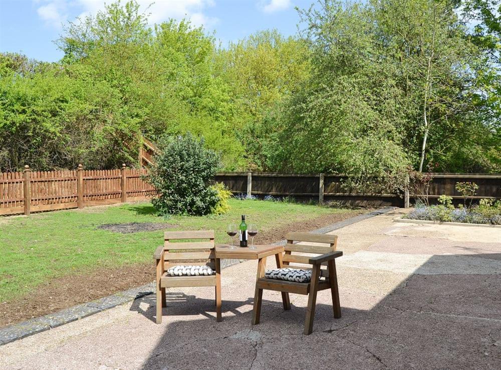 Garden with seating area at The Waiting Rooms in Cawston, near Norwich, Norfolk