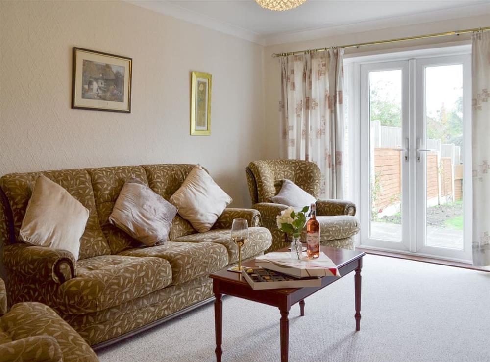 Spacious living room with French doors to garden at The Warren in Whitstable, Kent