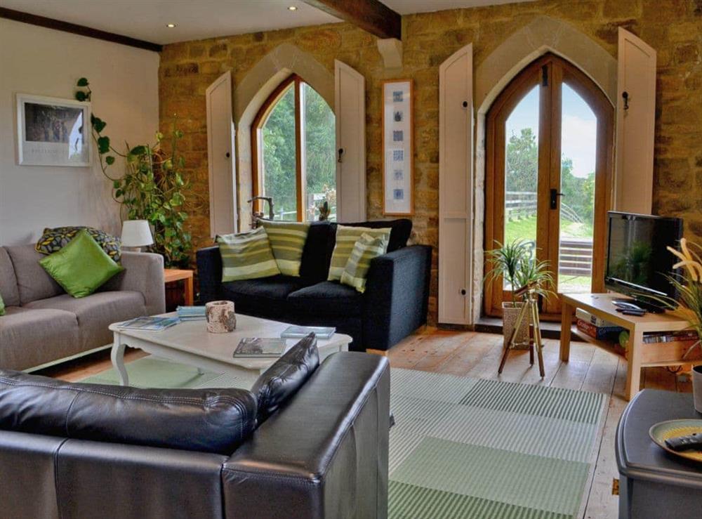 Comfortable living area with wooden floor and electric wood-burner at The Water Castle in Newton, Nr Corbridge, Northumberland., Great Britain