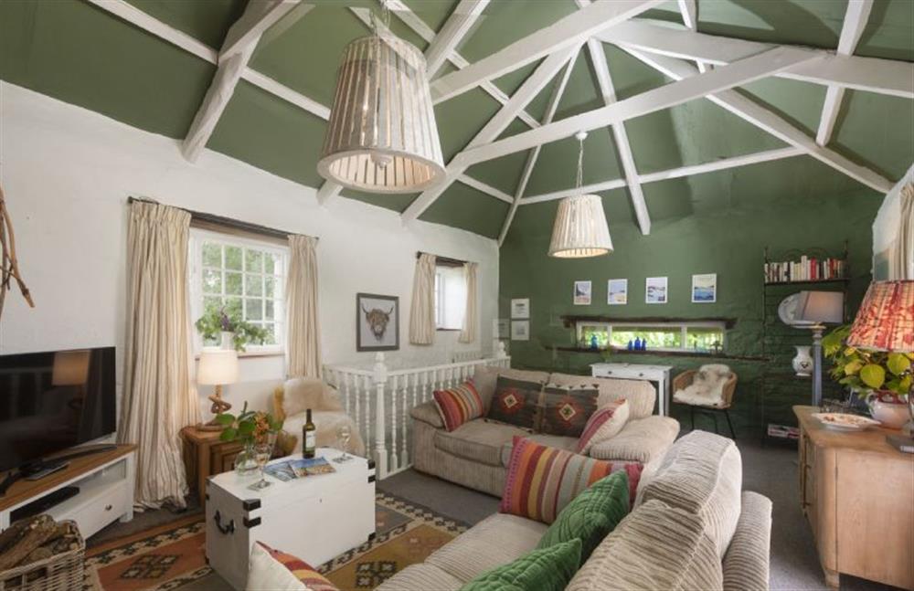 The sitting room boasts beautiful exposed beams and characterful soft furnishings