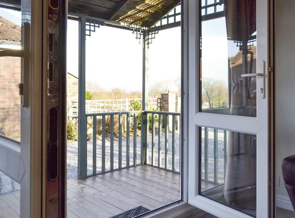 French doors to decked terrace at The Weaning Shed in Huggate, near Pocklington, North Yorkshire