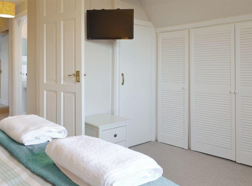Wall mounted TV and ample storage within the double bedroom at The Weaning Shed in Huggate, near Pocklington, North Yorkshire
