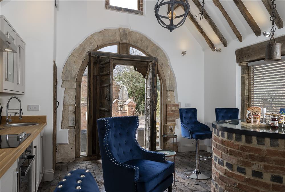Open-plan living space with exposed beams and brickwork at The Well House, Finstall nr Bromsgrove