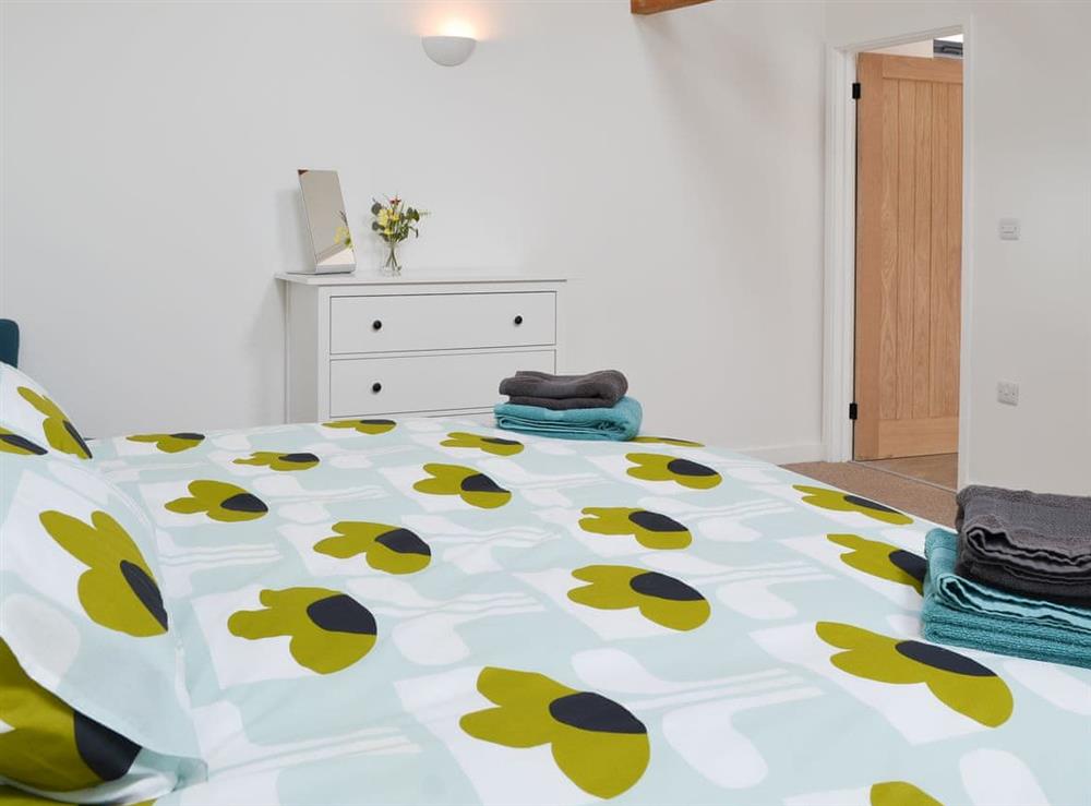 Beamed bedroom with en-suite at The Wheel House in Easthill, near Ottery St Mary, Devon