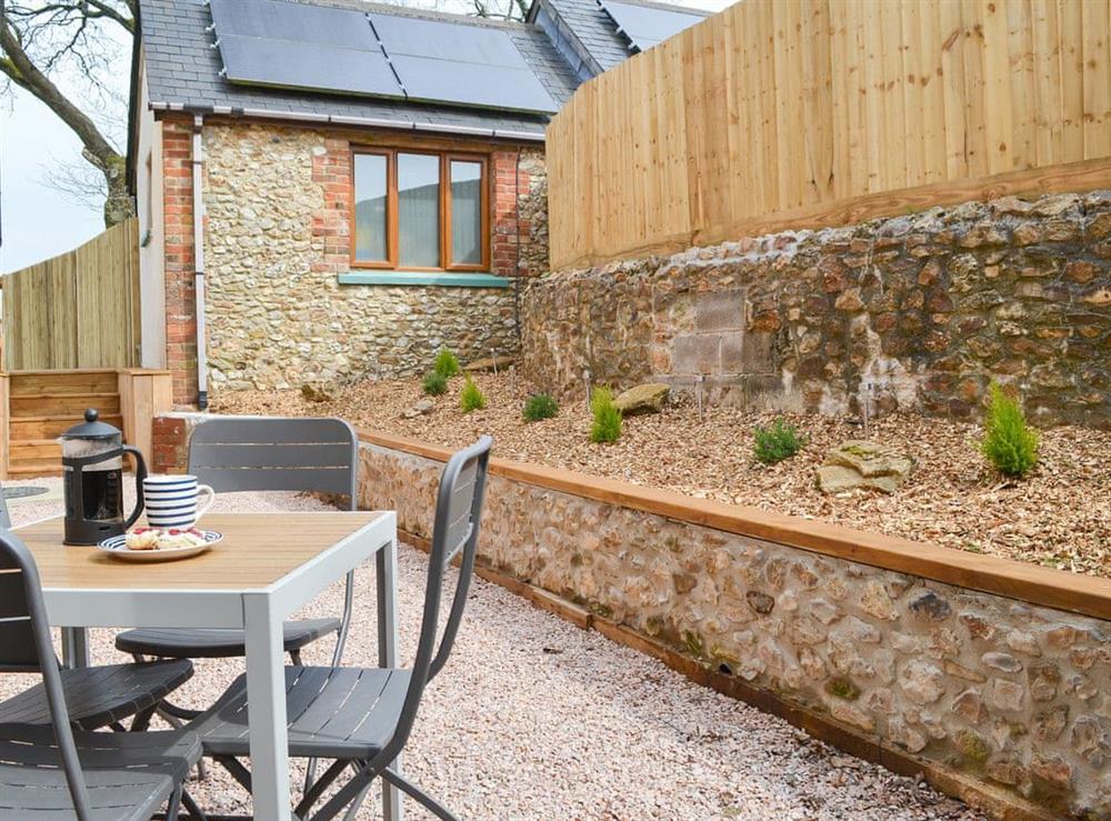 Delightful gravelled area with table and chairs at The Wheel House in Easthill, near Ottery St Mary, Devon