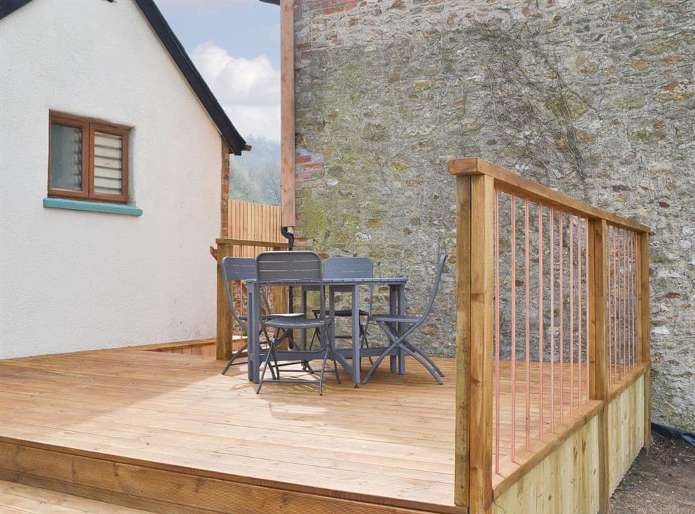 Exclusive deck with table and chairs at The Wheel House in Easthill, near Ottery St Mary, Devon