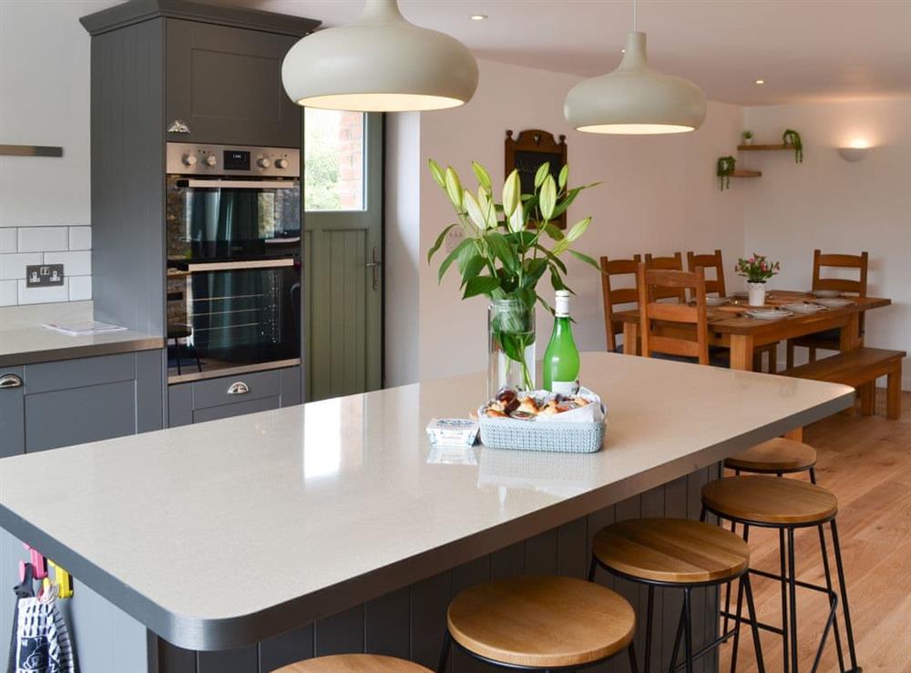Lovely kitchen with breakfast island at The Wheel House in Easthill, near Ottery St Mary, Devon
