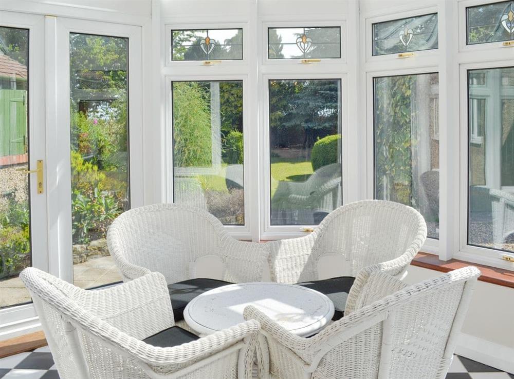 Furnished conservatory with garden views at The Whins in Ganton, near Filey, North Yorkshire
