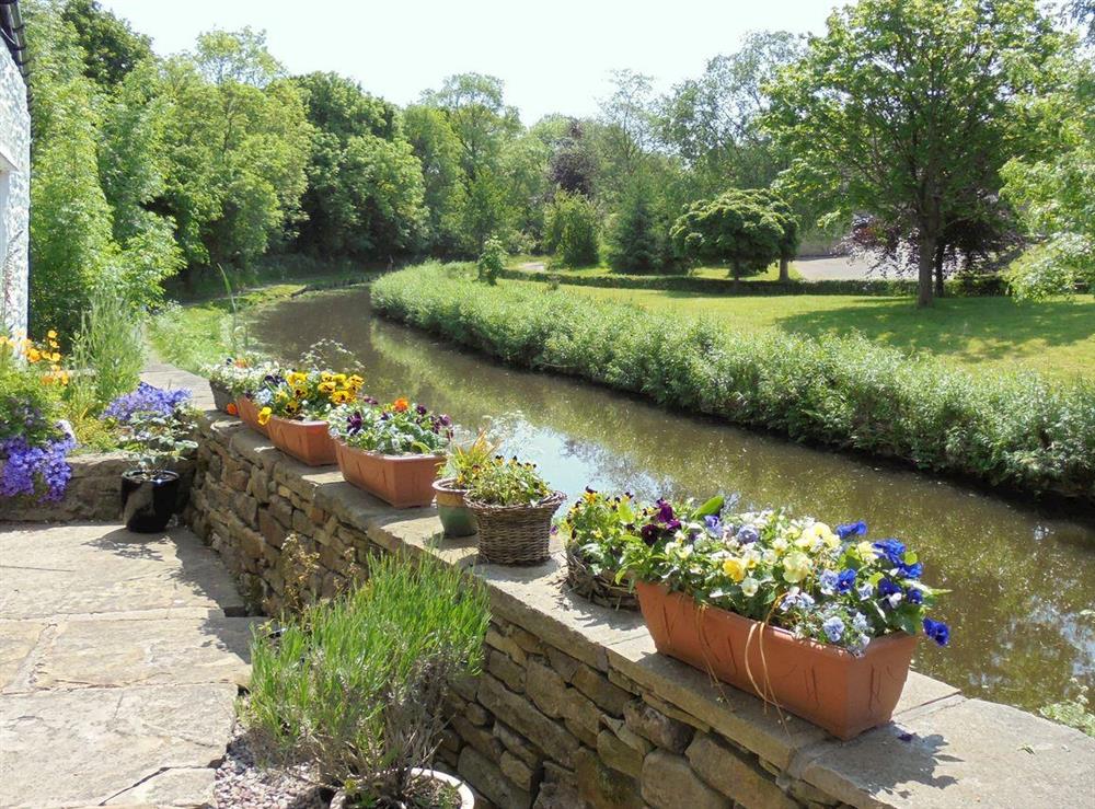 Courtyard garden overlooking canal (photo 2) at The White Cottage in Furness Vale, near Whaley Bridge, Derbyshire