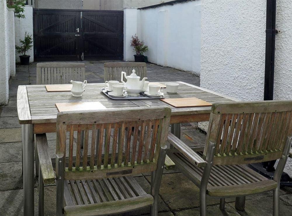 Courtyard with table and chairs for outdoor entertaining at The White Cottage in Keswick, Cumbria