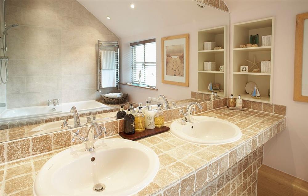 Family bathroom with a bath, twin basins, wc and overhead shower attachment at The White House, Little Weighton