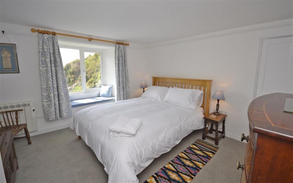 Bedroom 1 with sea views from the window seat. at The White House in Torcross
