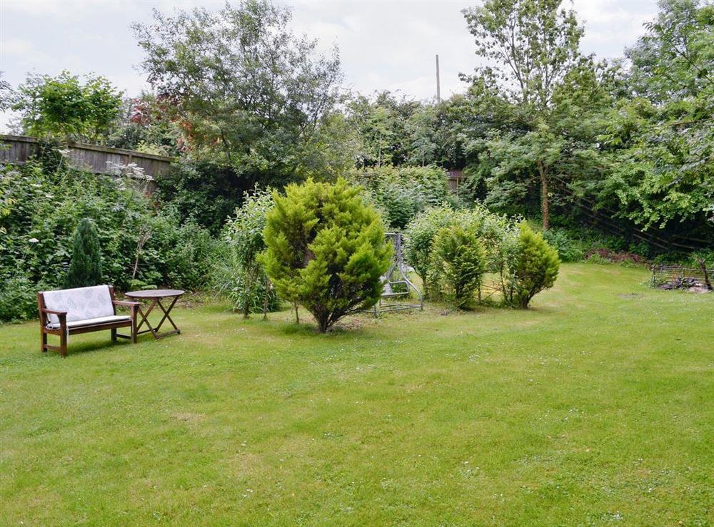 Enclosed lawned garden area at The Willows in Tatworth, near Chard, Somerset