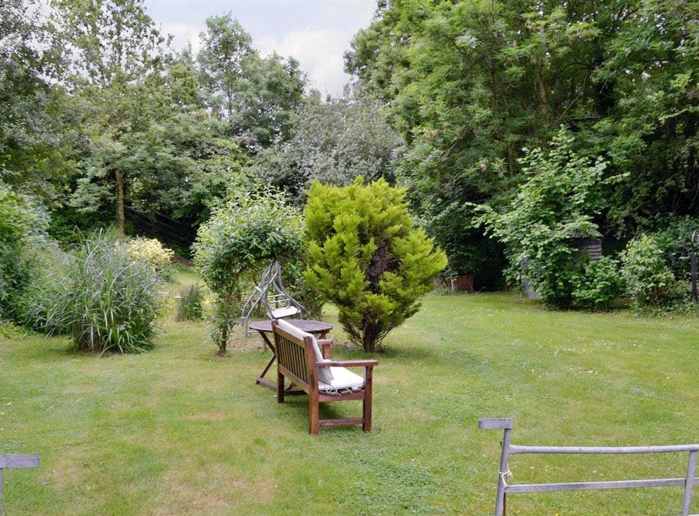 Mature garden with sitting-out furniture at The Willows in Tatworth, near Chard, Somerset