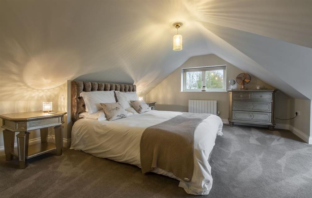 First floor: Bedroom with super king-size bed and views at The Woodshed at Green Valley Farm, Ubbeston