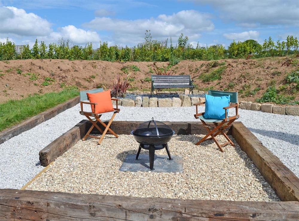 Inviting sitting-out-area with fire pit at The Wool Shed in Gorran, near St Austell, Cornwall