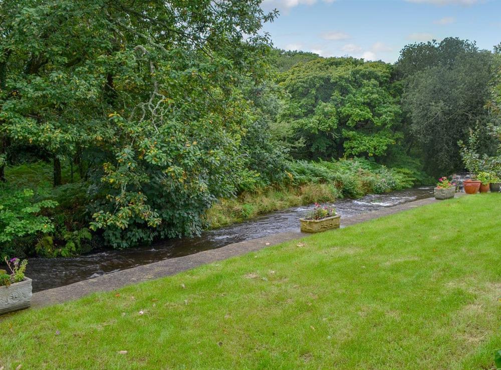 Lawned garden with river running alongside (unfenced) at Tryfan, 