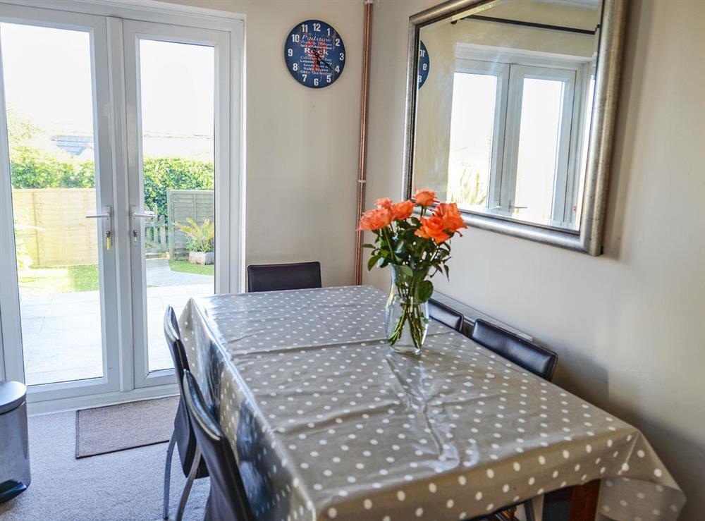 Inviting dining area with French doors leading to garden at The Yellow House in Padstow, Cornwall