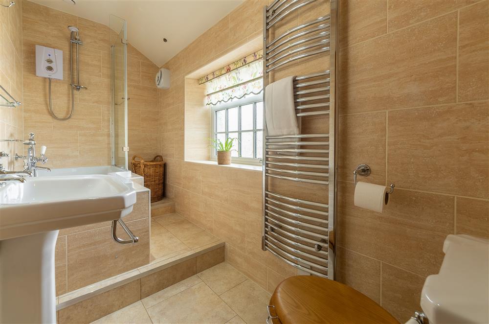 Family bathroom with step up to the bath with overhead shower at Theaked Stones, Leyburn