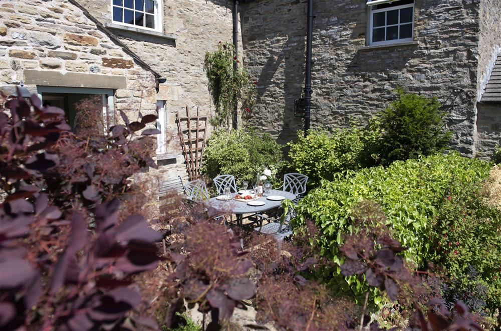 The front garden provides a lovely sun trap (photo 2) at Theaked Stones, Leyburn