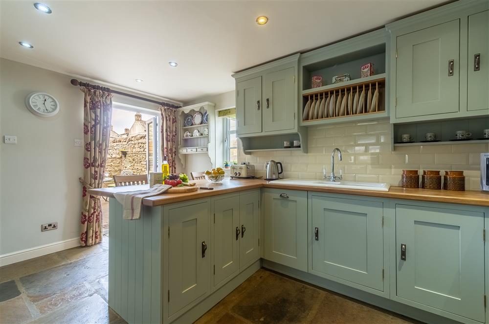 Well-equipped kitchen with breakfast bar (photo 2) at Theaked Stones, Leyburn