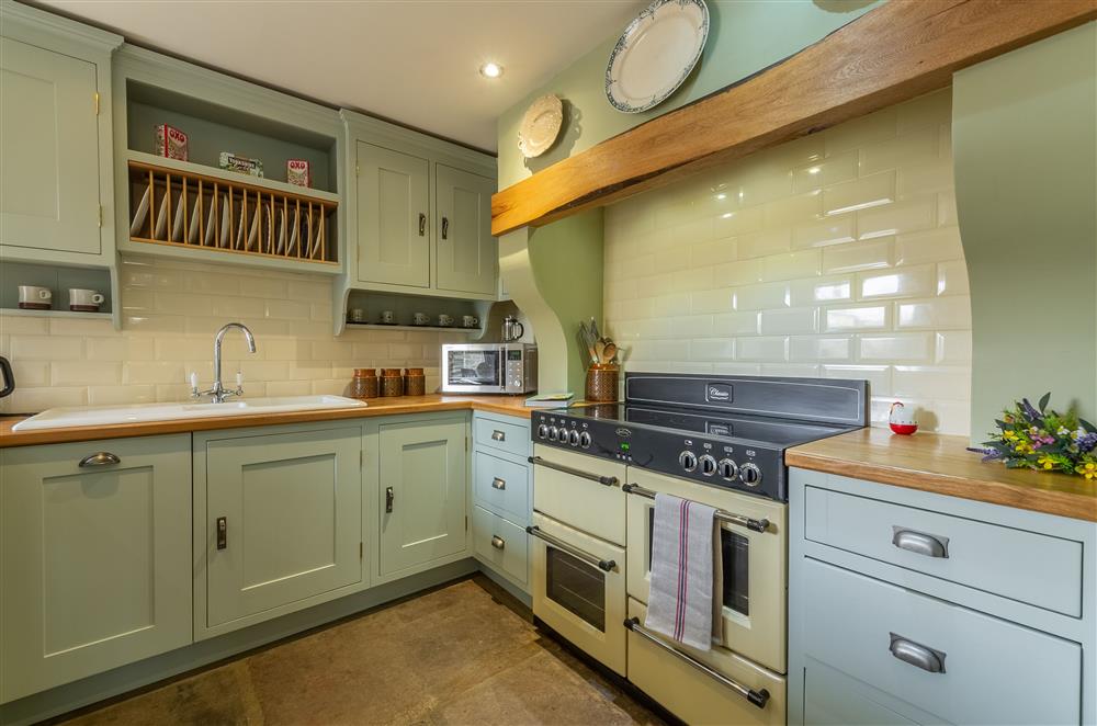 Well-equipped kitchen with breakfast bar at Theaked Stones, Leyburn