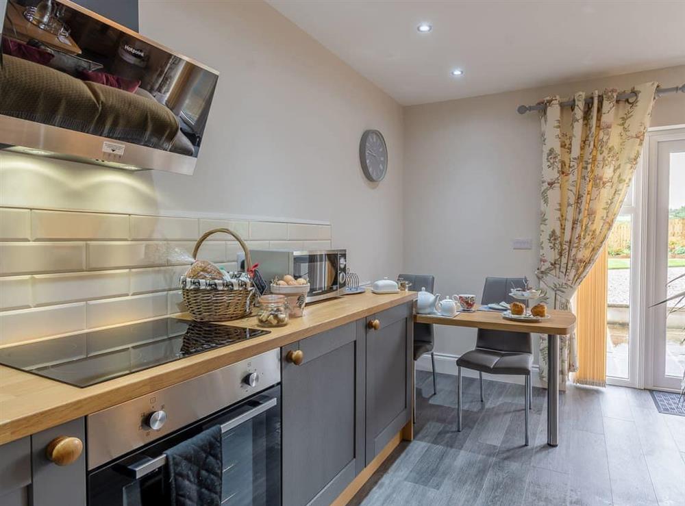 Fully appointed fitted kitchen with breakfast bar at Thistle Cottage in Staintondale, near Scarborough, Yorkshire, North Yorkshire