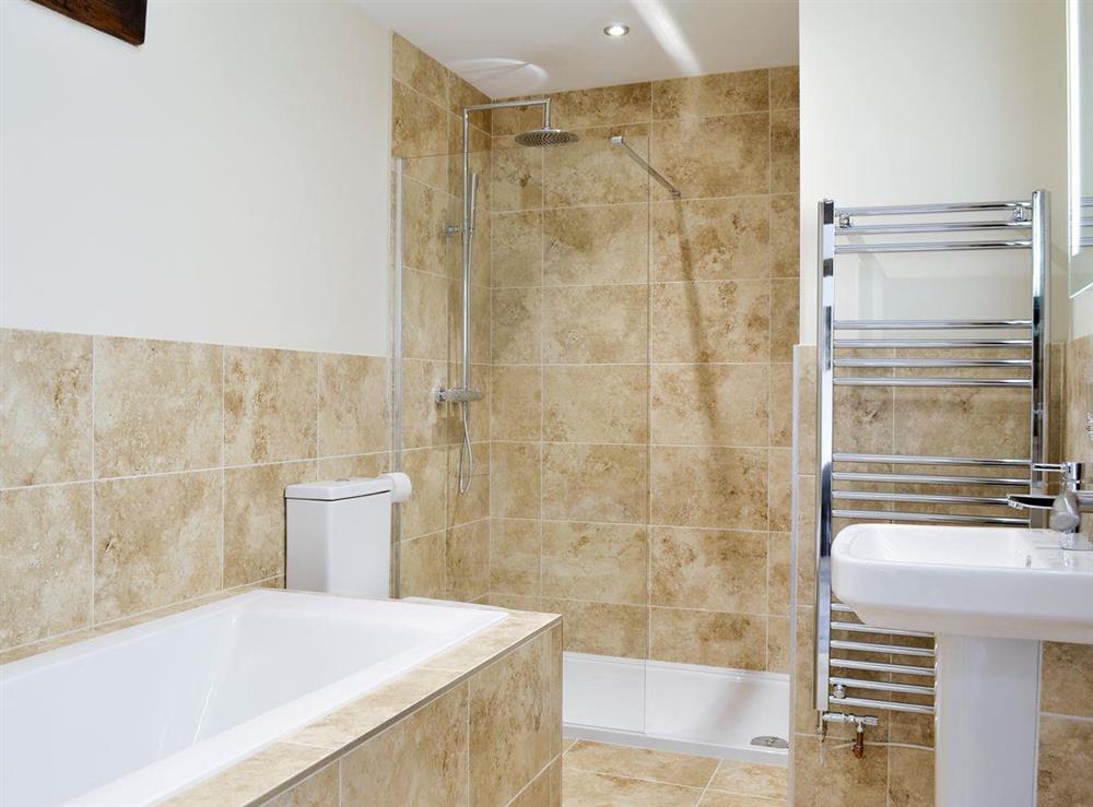 Bathroom with bath and separate walk-in shower area at The Cartshed, 