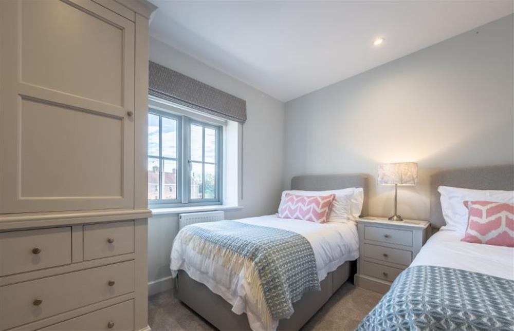 First floor: Bedroom four with twin beds at Thistledown, Thornham near Hunstanton