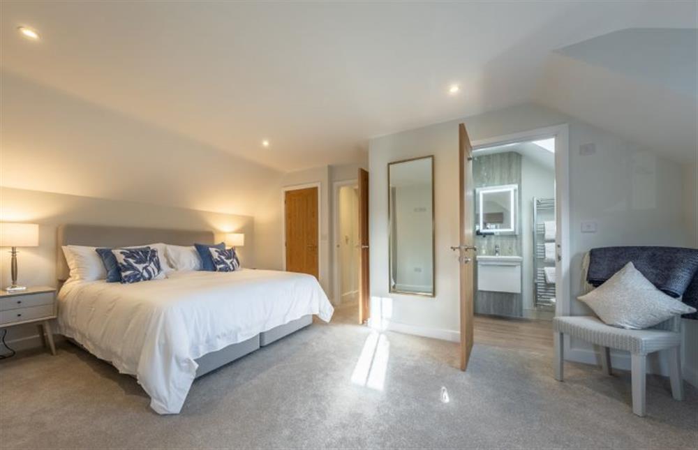 First floor: Master bedroom through to en-suite at Thistledown, Thornham near Hunstanton