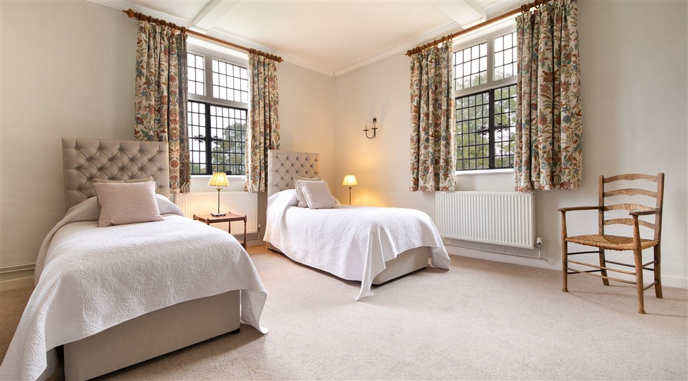 Bedroom 1 Rosier, with twin beds, on the first floor of Thorington Hall, Suffolk at Thorington Hall in Stoke By Nayland, Suffolk
