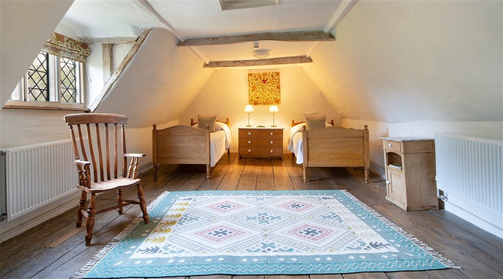 Bedroom 5 Heigham, with twin beds, on the second floor of Thorington Hall, Suffolk at Thorington Hall in Stoke By Nayland, Suffolk