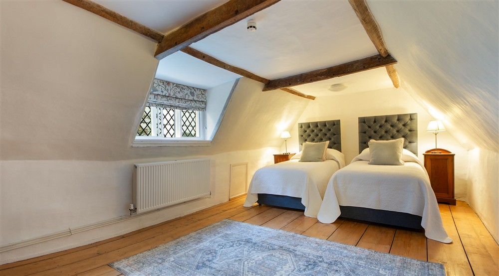 Bedroom 6 Wade, with twin beds, on the second floor of Thorington Hall, Suffolk at Thorington Hall in Stoke By Nayland, Suffolk